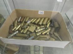 A collection of brass trench art lighters, bullets,