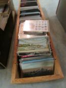 A large box of world/international postcards