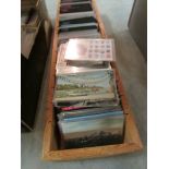 A large box of world/international postcards