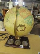 An illuminating desk globe with barometer, thermometer and hygrometer.