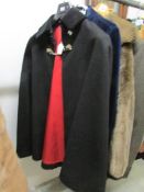 A Mister Carnaby Junior police cape with red lining and velvet collar.