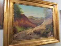 A large gilt framed oil on canvas of mountains signed V Leiozze, 1919.