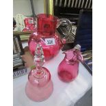 2 cranberry glass jugs and a cranberry glass bell