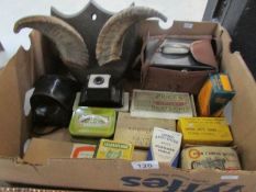 A box of old tins, cameras,