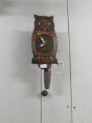 A ticking/moving eye owl clock with one weight and pendulum.
