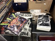 A collection of books on music including Punk, U2 by U2, Paparazzo,