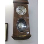 A wall clock with key and pendulum given to Constable John Lesley on his retirement from
