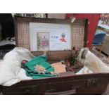 A vintage suitcase containing linen and a fraternal organisation sash