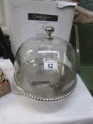 A boxed cake stand with glass dome cover