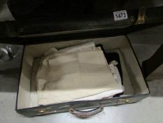 A vintage suitcase with 4 pairs of men's vintage trouser's including cricket whites.