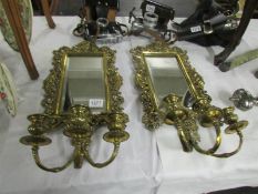 A superb pair of Victorian brass framed wall mirrors with triple candle sconces.