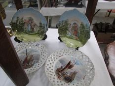 A pair of ribbon plated hand painted with ships and a pair of hand painted plates