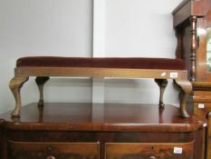 A long mahogany foot stool.