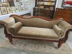 A mahogany framed double ended chaise longue.