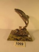 A white metal salmon paperweight