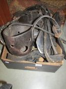 A quantity of antique leather horse tack.