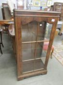 A walnut display cabinet.