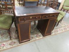 A 19th century mahogany kneehole desk with leather top and drawers to sides.