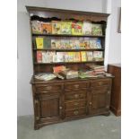 An oak dresser with 2 cupboard and centre bank of drawers.