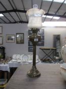 A brass oil lamp complete with shade and chimney