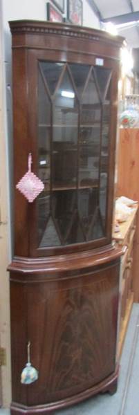 A mahogany glazed top corner cabinet