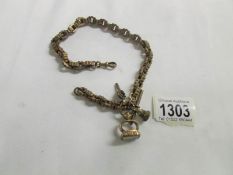An ornate watch chain with 2 fobs and key