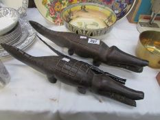 A pair of old African carved crocodiles and one other