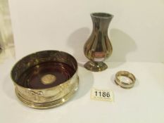 A silver wine coaster with wood base,