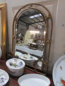 An arched gilt framed mirror