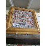 A framed and glazed sampler