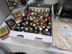 An assortment of spirit miniatures including Whisky, Gin, Brandy,