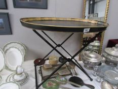 An oval metal tray on stand