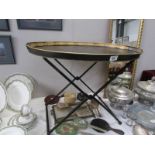 An oval metal tray on stand