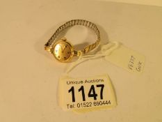 A Longines ladies 18ct gold cased wrist watch with rolled gold strap