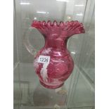 A cranberry glass Mary Gregory style jug