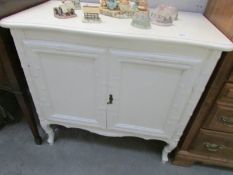 A white painted side cabinet