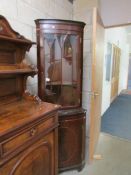 A mahogany corner cabinet.