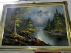 A gilt framed mountain scene