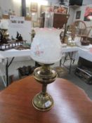 A brass oil lamp with shade and chimney, shade a/f.