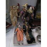 A collection of jester/harlequin dolls