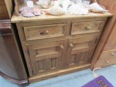 A pine 2 drawer 2 door cupboard