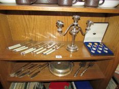 2 shelves of silver plate including candlestick.