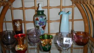 A shelf of coloured glass,