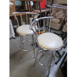 A pair of chrome bar stools.