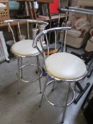 A pair of chrome bar stools.