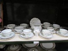 A shelf of German porcelain table ware.