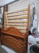 A 4'6" pine bedstead with mattress.