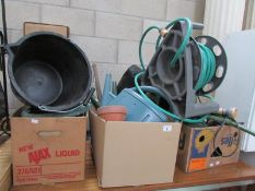 A mixed lot of garden items including hose pipe, watering can etc.