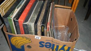 A box of LP records including boxed sets.