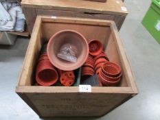 A tea chest of flower pots.